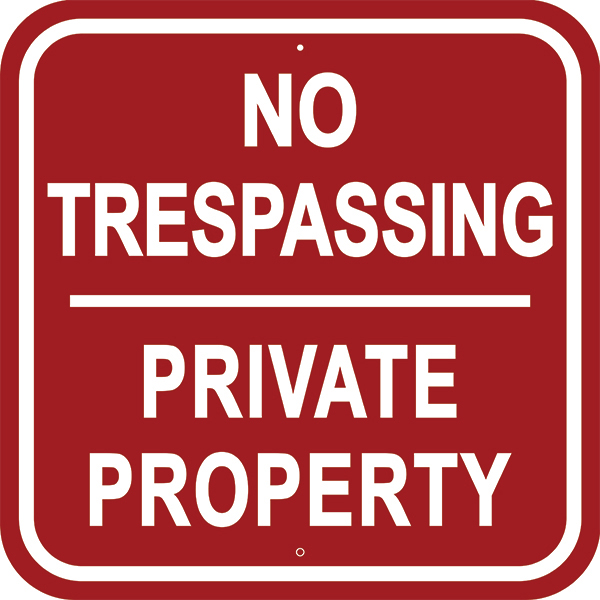 Image of No Trespassing Sign in red with white border and text
